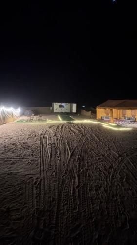 a field at night with tracks in the sand at Skyrak