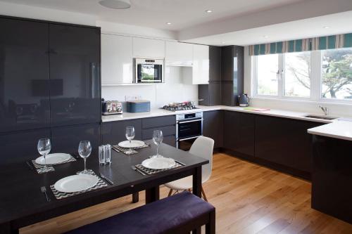 a kitchen with a table with wine glasses on it at Falmouth Self Catering Lodges in Falmouth