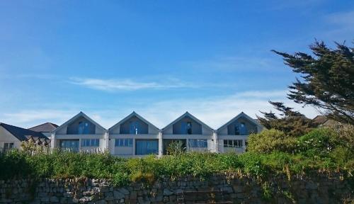a row of houses behind a stone wall at Falmouth Self Catering Lodges in Falmouth
