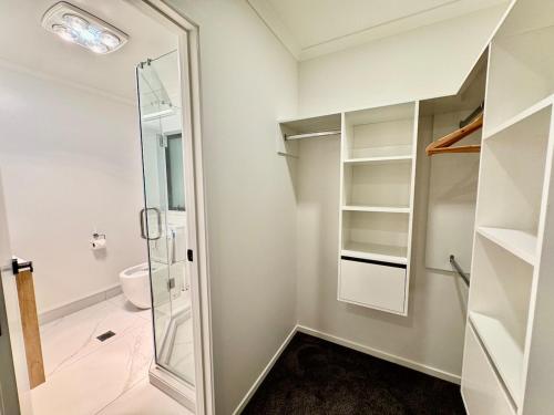 a bathroom with a glass shower and a toilet at New 4BR Family Home in Greenhill Park, Chartwell in Hamilton