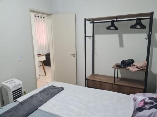 a bedroom with a large mirror and a bed at Belo Apto ao lado do Shopping in Franca