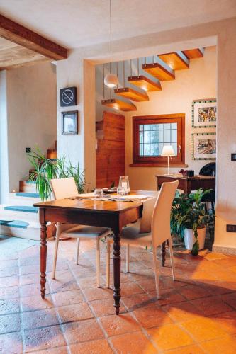 a dining room with a wooden table and chairs at B&B Lo Matsòn in Chambave