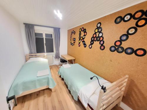 a hospital room with two beds and clocks on the wall at Stilvoll renoviertes 50m2 Apartment in Grünlage - ganze Unterkunft in Graz