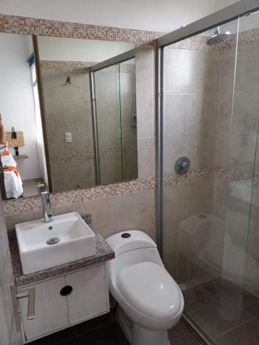 a bathroom with a toilet and a sink and a shower at SantaMartaTerrace in Santa Marta