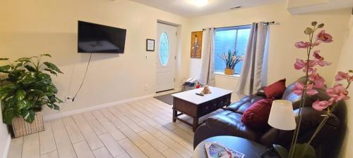 a living room with a couch and a table at Entire Huge Basement! Fast Wifi! Private Entrance! in Salt Lake City