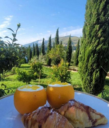 a plate of food with oranges and meat on it at Guesthouse Lord Byron in Tepelenë