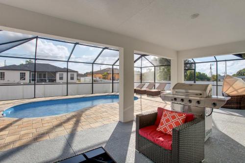 a backyard with a grill and a swimming pool at Furnished Lanai and Yard Comfy Lehigh Acres Getaway in Lehigh Acres
