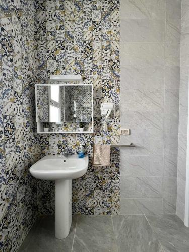 a bathroom with a sink and a mirror at Appartement Vue de Mer Pied dans l'eau in Gabès
