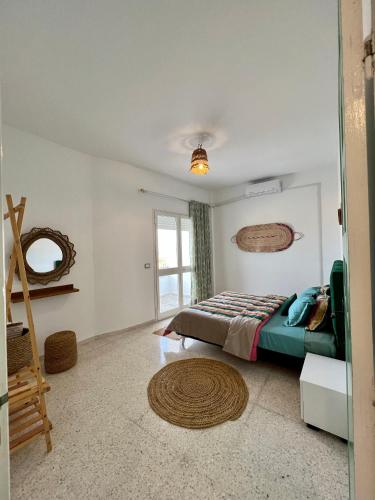 a bedroom with a bed and a window at Appartement Vue de Mer Pied dans l'eau in Gabès