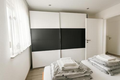 a bedroom with two beds and a mirror at Deluxe Apartment Seeblick in Friedrichshafen