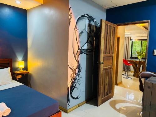 a bedroom with a bed next to a door at WN Hilltop B&B by Smart Stay 2600 in Baguio