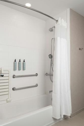 a bathroom with a shower with a white shower curtain at Residence Inn Pearland in Pearland