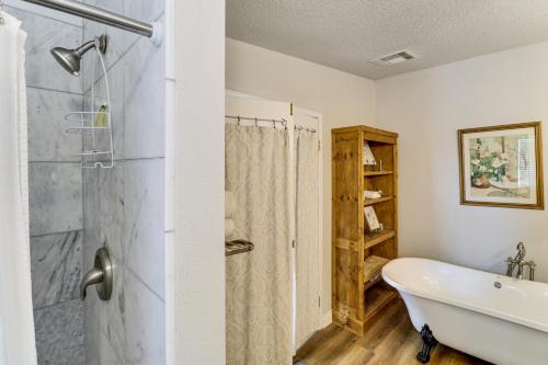 a bathroom with a tub and a shower and a sink at Scenic Sandia Mtn Views! Cozy Rio Rancho Retreat in Paradise Hills