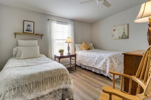 a bedroom with two beds and a chair and a window at Scenic Sandia Mtn Views! Cozy Rio Rancho Retreat in Paradise Hills
