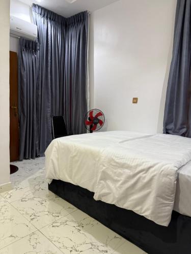 a bedroom with a bed and a chair in it at Larj residence in Lagos