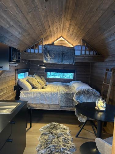 a bedroom with a bed in a tiny house at Arctic circle cabin 2 in Rovaniemi