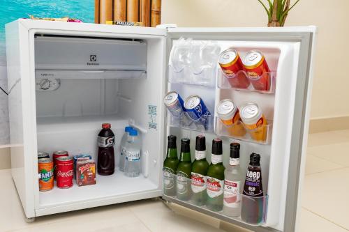 een open koelkast gevuld met drankjes en frisdrank bij Prime Motel Piracicaba in Piracicaba