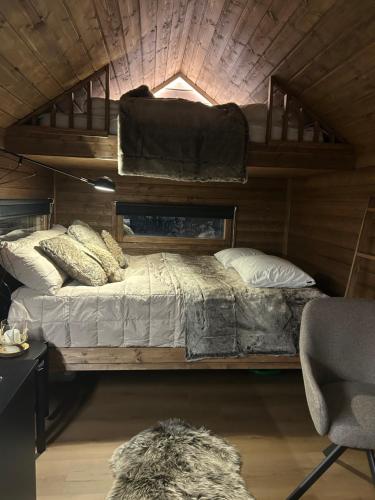 a bedroom with two bunk beds in a cabin at Arctic circle cabin 2 in Rovaniemi