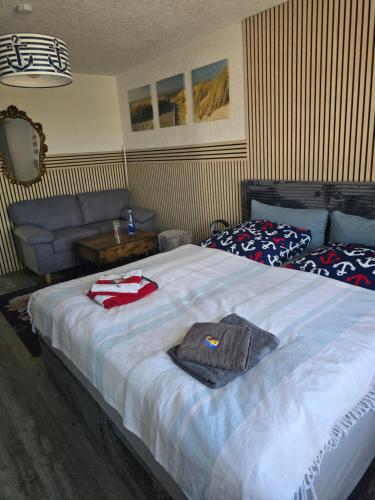 a bedroom with a large bed with towels on it at Heimathafen Ückeritz Boutique Hotel in Ueckeritz