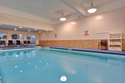 a large swimming pool in a building at Holiday Inn & Suites Houston NW - Willowbrook by IHG in Houston