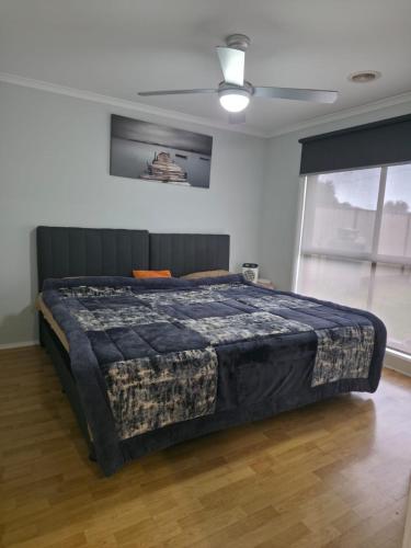 a large bed in a bedroom with a ceiling at Westcott in Rockbank