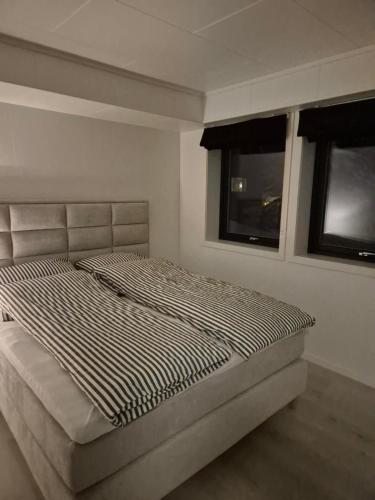 Ένα ή περισσότερα κρεβάτια σε δωμάτιο στο Senja Laukhella