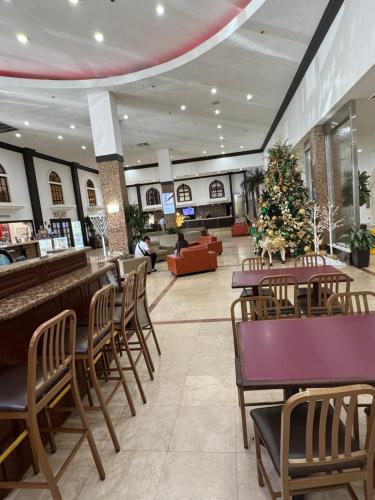a restaurant with tables and chairs and a christmas tree at Miami Sunny Isles Beach Ocean Front Resort Condo with balcony Pool, Beach,Gym,Valet Parking in Sunny Isles Beach