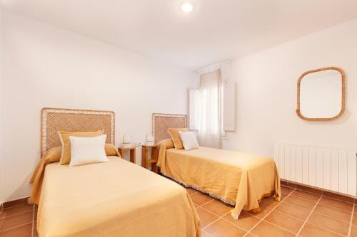 a room with two beds and a mirror at Casa Rosari I - Jardín & Parking Privado in Vilassar de Mar