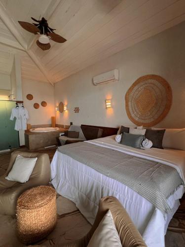 a bedroom with a large bed and a couch at Pier Beach Club in Cabo Frio