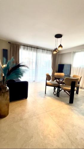 a living room with a couch and a table at Appartement cosy proche de la Croisette et du Palais des Festivals in Cannes