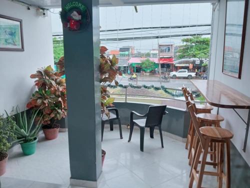 a patio with chairs and tables and a view of a street at Casa Hotel El Eden in Carepa