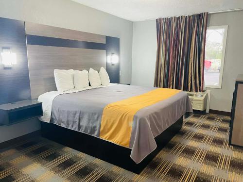 Giường trong phòng chung tại Travelodge by Wyndham Sellersburg