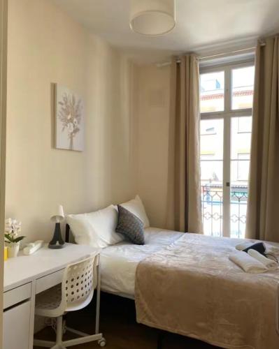 a bedroom with a bed and a desk and a window at Lovely Rooms in Camden Town, Central London in London
