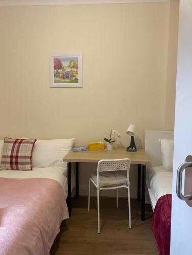 a bedroom with a desk with a chair and a table at Lovely Rooms in Camden Town, Central London in London
