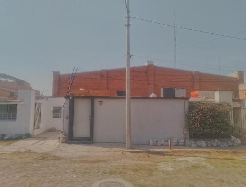 a white building with a pole in front of it at viva la vida in Querétaro