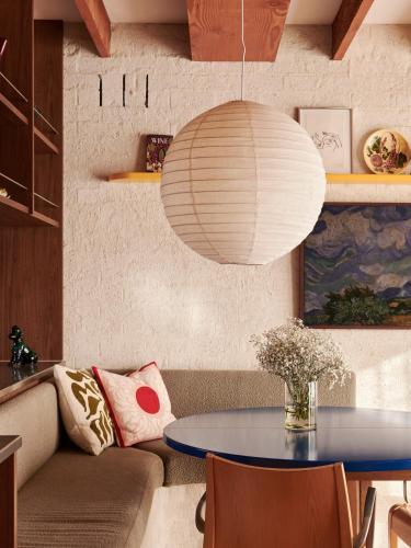 a living room with a table and a lamp at Cosy Cottage in North Fitzroy in Melbourne