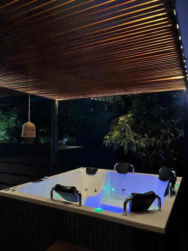 a bath tub with two faucets in a room at Casa Moderna en el Bosque Jacuzzi y Deck Privado in Mazo