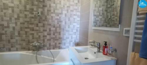 a bathroom with a sink and a bath tub at Apartment222 2 rooms Al Bousten Hammamet in Hammamet Sud