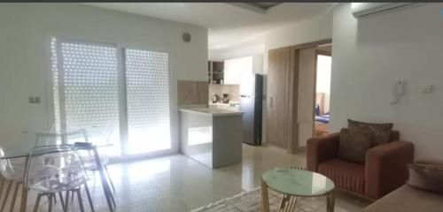 a living room with a couch and a table at Apartment222 2 rooms Al Bousten Hammamet in Hammamet Sud