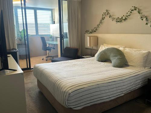 a bedroom with a bed with a pillow on it at Beautiful rooms in An Apartment Free Parking in Brisbane