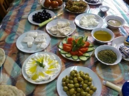 a table with plates of food on a table at Wadirum Leen camp in Wadi Rum