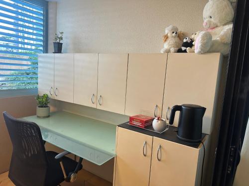 a desk with stuffed animals on top of it at Beautiful rooms in An Apartment Free Parking in Brisbane
