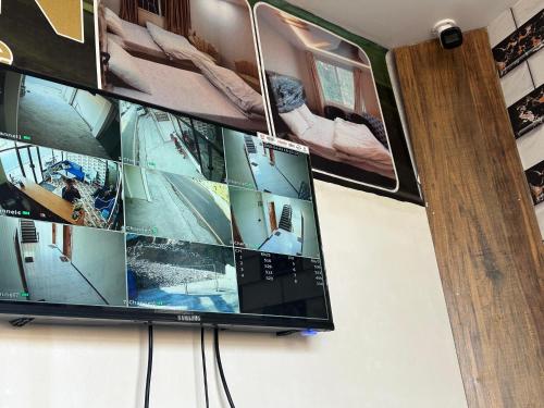 a flat screen tv hanging on a wall at Askari Lodges Murree in Murree