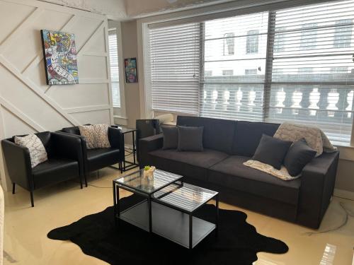 a living room with a couch and a table at Downtown Memphis Luxury Condo in Memphis