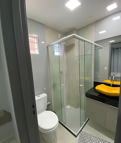 a bathroom with a toilet and a glass shower at Apto elegante no Catolé 28 in Campina Grande