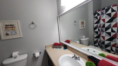 a bathroom with a sink and a mirror at My Home in Orlando in Kissimmee