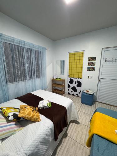 a bedroom with two beds and a cow painting on the wall at Suíte Toy Story - Pousasa Castelo do Luar in Penha