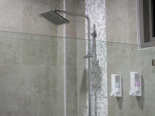 a shower with a glass door in a bathroom at SODA POP Samui pool villa in Bophut 