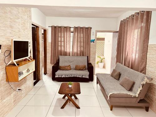 Et tv og/eller underholdning på Casa em Bertioga com piscina aquecida Sitio família ROCHA