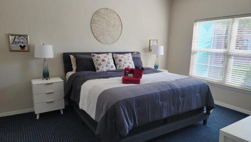 a bedroom with a bed with a red box on it at My Home in Orlando in Kissimmee